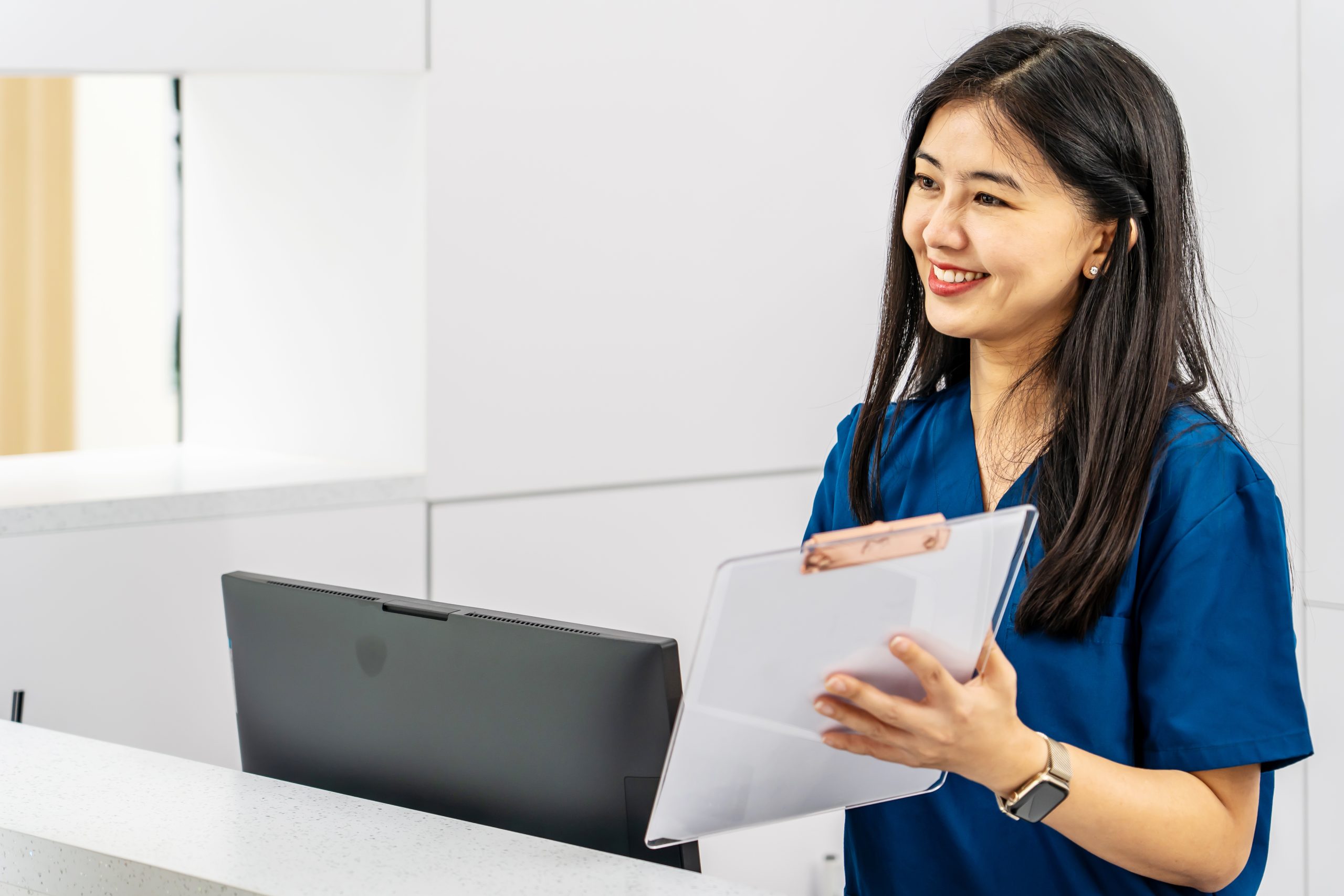 Asian female working with medical billing coding health records